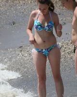 Candid girl on the beach and walking nearby in sexy bikinis