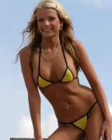 A girl in tight skirt showing a yellow string bikini with cameltoe outside