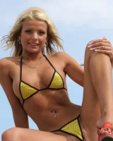 A girl in tight skirt showing a yellow string bikini with cameltoe outside