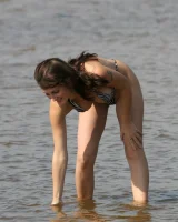 Exciting chick in bikini in the sea flashing a nipple