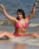 Sexy brunette hottie in pink bikini on the beach