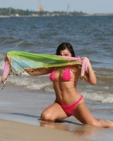 Sexy brunette hottie in pink bikini on the beach