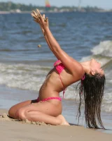 Sexy brunette hottie in pink bikini on the beach