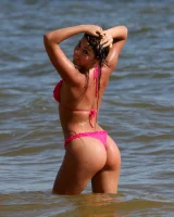 Sexy brunette hottie in pink bikini on the beach