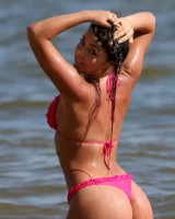 Sexy brunette hottie in pink bikini on the beach