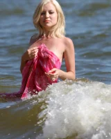 Wondeful topless blonde in tiny bikini in the sea, shore and beach