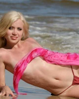 Wondeful topless blonde in tiny bikini in the sea, shore and beach