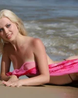 Wondeful topless blonde in tiny bikini in the sea, shore and beach