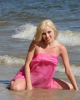 Wondeful topless blonde in tiny bikini in the sea, shore and beach