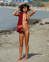 On the beach in black bikini with the nipples puffy