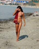 On the beach in black bikini with the nipples puffy