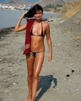On the beach in black bikini with the nipples puffy