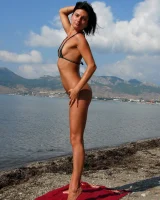 On the beach in black bikini with the nipples puffy