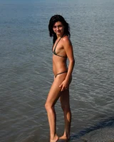 On the beach in black bikini with the nipples puffy