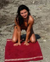 On the beach in black bikini with the nipples puffy