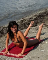 On the beach in black bikini with the nipples puffy
