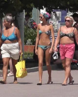 Candid chicks walking on the beach in sexy bikinis