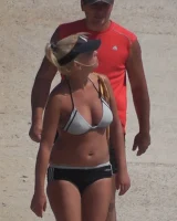 Candid chicks walking on the beach in sexy bikinis
