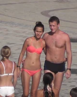 Candid chicks walking on the beach in sexy bikinis