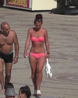 Candid chicks walking on the beach in sexy bikinis
