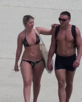 Candid chicks walking on the beach in sexy bikinis