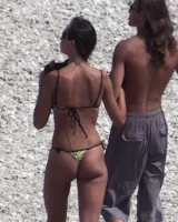 Candid chicks walking on the beach in sexy bikinis