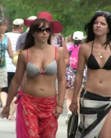 Candid chicks walking on the beach in sexy bikinis
