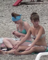 Candid chicks walking on the beach in sexy bikinis