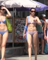 Real candid girls in bikinis walking on the streets