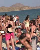 Candid girls with sexy bodies walking on the beach