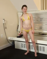 Playful teen in yellow micro bikini with cameltoe