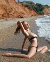 Busty girl in black bikini is swimming nude in the sea