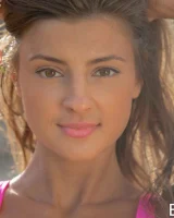 Tall sexy beauty is in the pool in coloful bikini