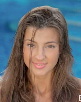 Tall sexy beauty is in the pool in coloful bikini