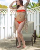 Orange micro bikini redhead is in the backyard with puffy nipples