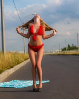 Young girl in red furry bikini on the road