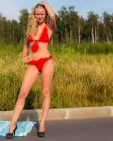 Young girl in red furry bikini on the road