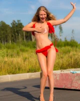 Young girl in red furry bikini on the road