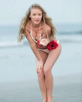Girl in white bikini and topless on the beach