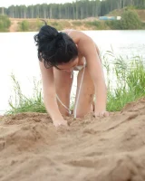 Teen in silver bikini swimming in the lake