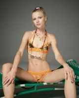 Cute slim body girl in sexy motley bikini