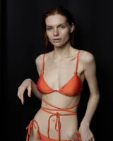 Busty hottie in orange bikini