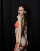 Busty hottie in orange bikini