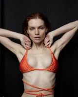 Busty hottie in orange bikini