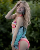 Sexy baby in colorful bikini swimming nude in the pool