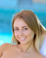 Exciting smiling petite slim body blonde in motley blue bikini by the pool