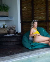 Sexy puffy nipples chick is chillin by the pool in yellow bikini