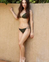 Slim body brunette clothes dark green bikini and waters her tits with puffy nipples