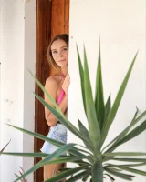 Slim body brunette wearing pink bikini with denim shorts has puffy nipples