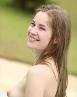 Perfect beautiful teen is by the pool in blue bikini and nude